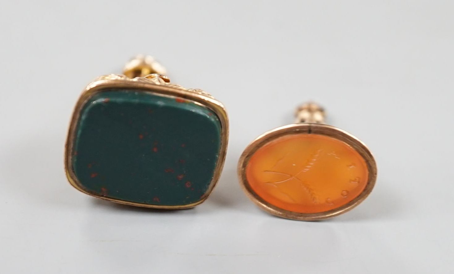 A late Victorian yellow metal and carnelian set fob seal, 23mm and a George V 9ct gold and bloodstone set fob seal.